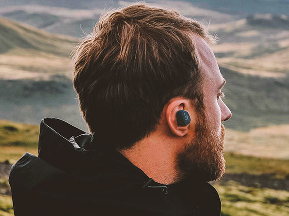 man wearing headphone in nature